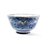 A Dutch Delft Punch Bowl, 18th century, painted in blue with chinoiserie landscapes in ogee panels