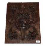 An Oak Panel, in 17th century style, carved in high relief with the head of a girl in a foliate