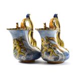 A Pair of Italian Maiolica Ewers, in 16th century style, of bag form with loop handles painted