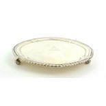 A George III Silver Waiter, by John Carter, London, 1771, shaped circular and with gadrooned rim, on