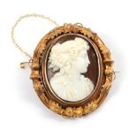 A Cameo Brooch, the classical figure within a frame with thistle and leaf decoration, with a