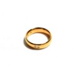 A 22 carat gold diamond set band ring, estimated diamond weight 0.10 carat approximately, finger