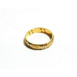 An 18 carat two colour gold diamond set textured band ring, finger size L1/2. The ring is in good
