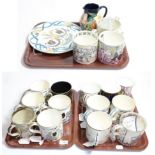 Three trays of Wedgwood commemorative mugs including one example designed by Eric Ravilious; a