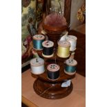 ^ A Victorian mahogany cotton reel stand/pin cushion