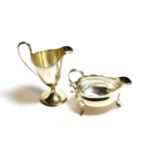 A George III silver sauceboat and a George III silver cream-jug, the sauceboat by Walter Brind,