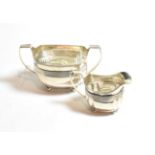 A George III silver cream-jug and sugar-bowl, the cream-jug by Duncan Urquhart and Naphtali Hart,