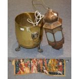 A brass coal bin with lions mask handles, an Indian lamp and a reproduction tapestry