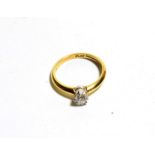 An 18 carat gold diamond solitaire ring, a round brilliant cut diamond in a claw setting, to knife