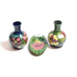 Moorcroft pottery, two small baluster vases and an ashtray
