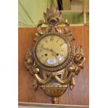 A reproduction giltwood cartel clock