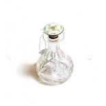 A cut glass pear shaped scent flask, with enamelled sterling silver stopper