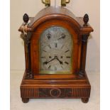 An oak striking table clock, circa 1890, arched case with acorn finials, side sound frets,