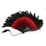 A Dramatic Feather Fan, late 19th century, the monture of wood painted black, the central body of