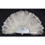 A Large Late 19th Century Mottled Ostrich Feather Fan, mounted on quite substantial white Mother-