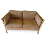 Stouby: A Danish Design Beech Framed Two-Seater Sofa, covered in light brown tan leather, with six