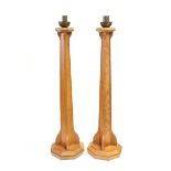 A Pair of Arts and Crafts English Oak Candlesticks, designed by Peter Johnson, made by Thompson &
