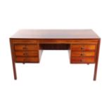 A 1970's Rosewood Desk, of rectangular form, one side fitted with three drawers, the other as a