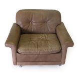 A 1970's Danish Armchair, covered in light brown, buttoned and stitched leather, with square form