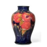 William Moorcroft (1872-1945): A Pomegranate Pattern Baluster Vase, on a blue/green ground, green