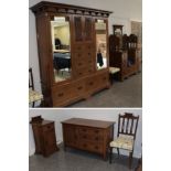 An Arts & Crafts Oak Six Piece Bedroom Suite, comprising a Wardrobe, the cornice above two