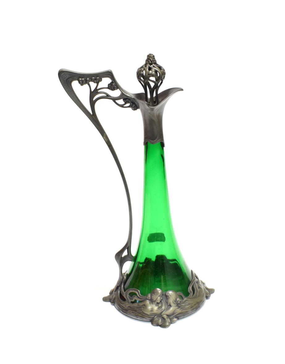 An Art Nouveau WMF Claret Jug and Stopper, No.191, with tapering green glass body, the plated mounts