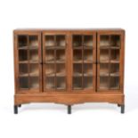 Gordon Russell (1892-1980): A Walnut and Ebony Bookcase, with four glazed doors enclosing six