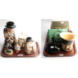 A collection of items to include a brass reliquary, glass bottle, character mugs of Winston