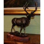 A reproduction bronzed metal model of a stag