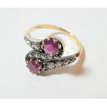 A ruby and diamond two stone twist ring, and S-shaped twist comprising of three sections of