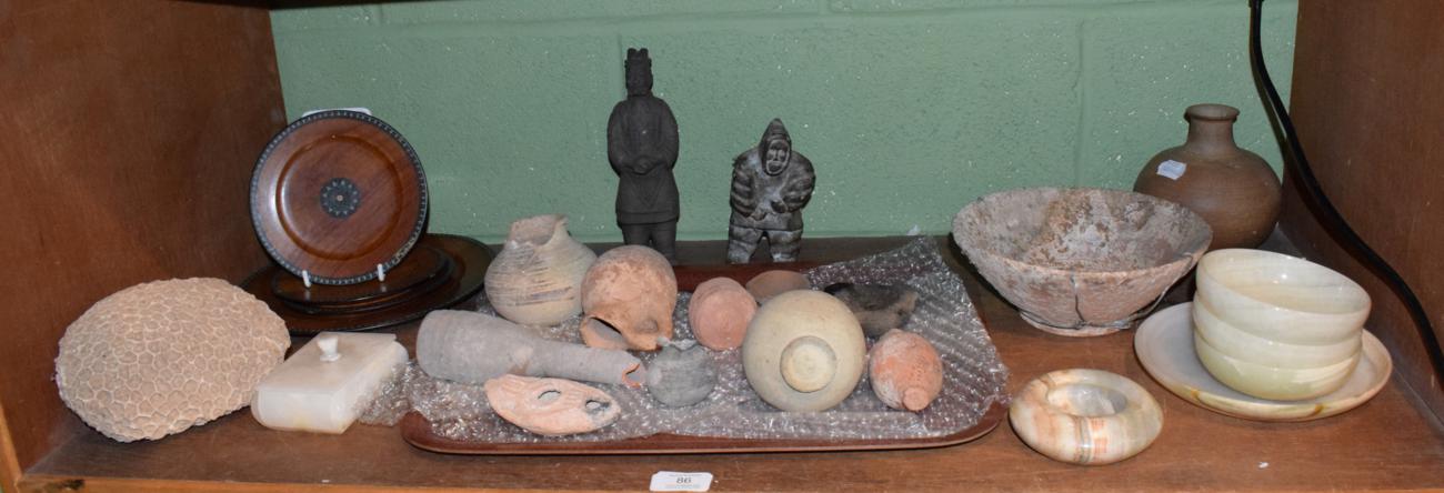 A small group of antiquities including Roman terracotta oil lamps and vessels; together with a sea