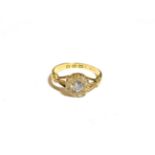 An 18 carat gold diamond cluster ring, the central old cut diamond within a border of thirteen old