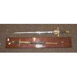 An Elizabeth II presentation sword by Wilkinson Swords, the double edge steel blade etched with