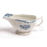 A Lowestoft porcelain sauceboat, circa 1775, printed in underglaze blue with flower sprays within