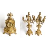 A modern gilt-metal striking mantle clock and a six light candelabra garniture (3)