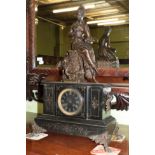 A Victorian black slate striking mantel clock, case surmounted by a spelter figure of a lady