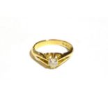 An 18 carat gold diamond solitaire ring, the old cut diamond in a yellow claw setting, to a