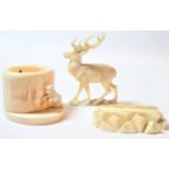 An Austrian ivory model of a stag, circa 1900, naturalistically modelled on a mound base, 6cm