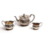 A three piece silver tea service, by Elkington & Co, Sheffield, 1904, each piece fluted and engraved