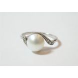 A cultured pearl and diamond ring, the central cultured pearl to asymmetric old cut diamond set