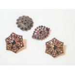 Two garnet brooches and a pair of earrings, a lozenge shaped cluster brooch of foil backed