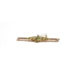 A peridot and seed pearl bar brooch, stamped '9CT', length 5.7cm . Gross weight 3.69 grams.