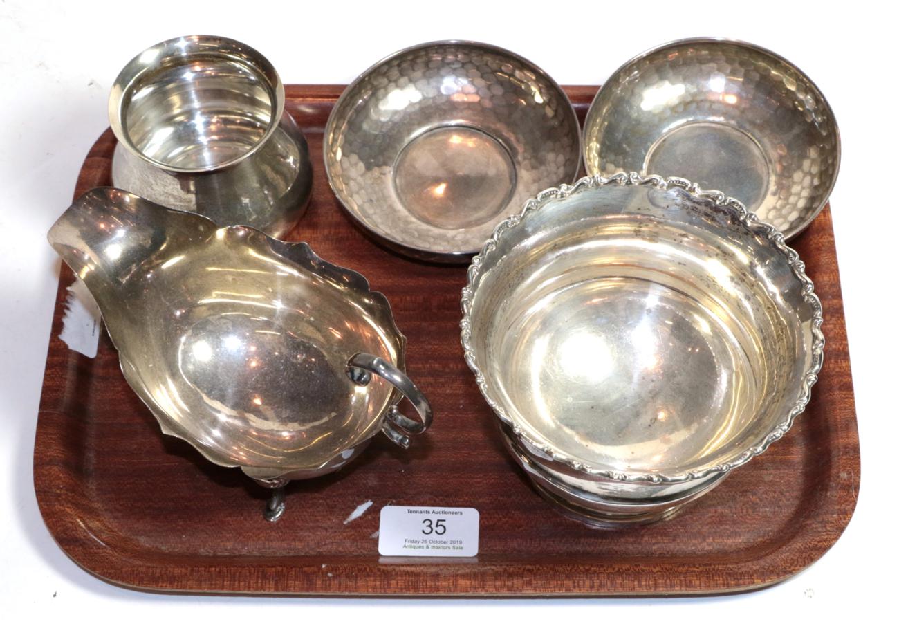 A group of silver including: a pair of hammered bowls, by Cooper Brothers & Sons Ltd., Sheffield,