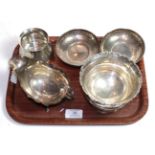 A group of silver including: a pair of hammered bowls, by Cooper Brothers & Sons Ltd., Sheffield,