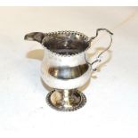 A George III silver cream-jug, maker's mark NS and AN, London, 1766, baluster and with beaded foot
