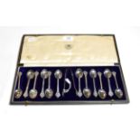 A cased set of twelve silver teaspoons with tongs, Goldsmiths and SIlversmiths Co., Britannia