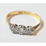 A diamond three stone ring, stamped '18CT' and 'PLAT', finger size P1/2. Gross weight 2.1 grams.