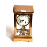 A brass and champleve enamel four glass striking mantel clock, circa 1900, champleve enamel borders,