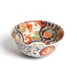 A Japanese Imari bowl, Meiji period, typically painted with dragons and foliage