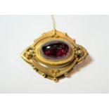 A Victorian carbuncle garnet brooch, measures 3.9cm by 3cm . Previous repair. Gross weight 9.02